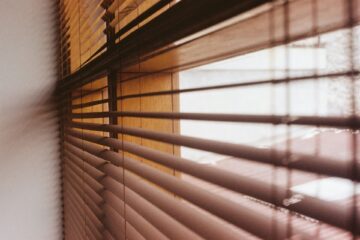 Light shining through blinds showing the best blinds for every room in the house