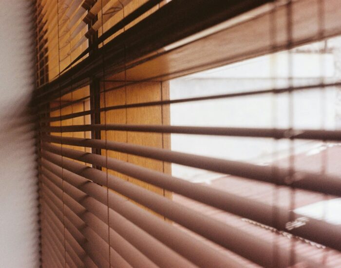 Light shining through blinds showing the best blinds for every room in the house
